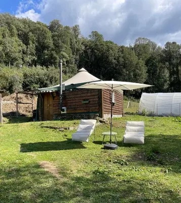 a blue building with two chairs and a gazebo at Cabane 2 in Olivese