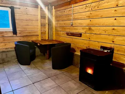 a room with a table and chairs and a stove at Cabane 2 in Olivese