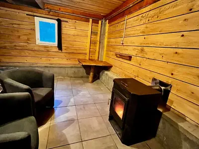 a room with a woodburning stove in a cabin at Cabane 2 in Olivese