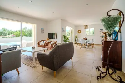 a living room with a couch and a table at Villa Clara piscine chauffée in Prunelli-di-Fiumorbo