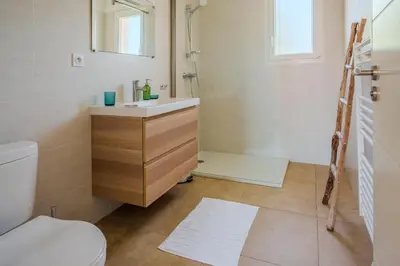 a bathroom with a sink and a shower and a toilet at Villa Clara piscine chauffée in Prunelli-di-Fiumorbo