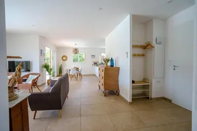 a living room with a kitchen and a dining room at Villa Camille in Prunelli-di-Fiumorbo