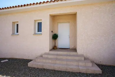 a building with stairs leading to a door with a plant at Villa Camille in Prunelli-di-Fiumorbo
