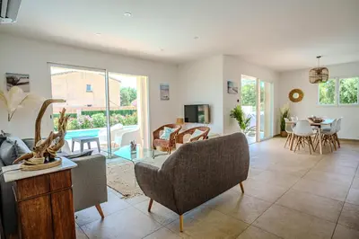 a living room with a couch and a table at Villa Camille in Prunelli-di-Fiumorbo