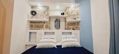 a room with a bed with two pillows on it at Superbe appartement en plein coeur d'Ajaccio in Ajaccio
