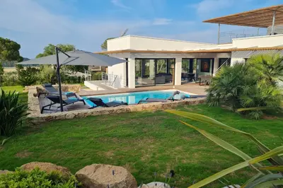 a house with a swimming pool in a yard at Villa Maria 12 pers piscine chauffée 5 min plage en voiture in Sainte-Lucie de Porto-Vecchio