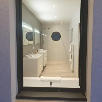 a white bathroom with two sinks and a mirror at Villa Maria 12 pers piscine chauffée 5 min plage en voiture in Sainte-Lucie de Porto-Vecchio