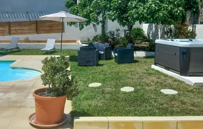 a yard with chairs and an umbrella next to a pool at Gorgeous Apartment In Propriano in Propriano