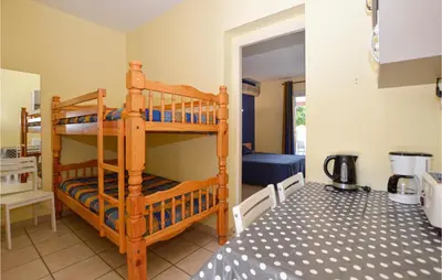 a bedroom with two bunk beds in a room at Gorgeous Apartment In Propriano in Propriano