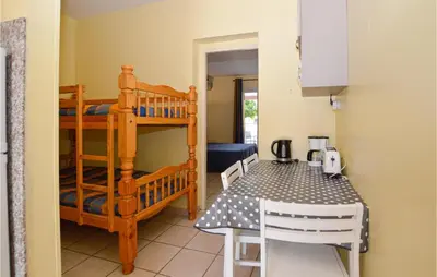a room with a dining table and a bunk bed at Gorgeous Apartment In Propriano in Propriano