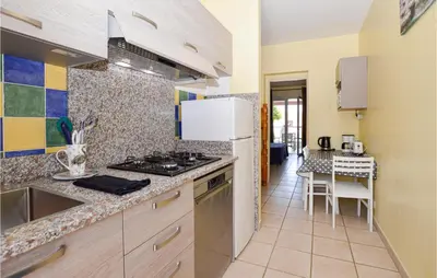 a kitchen with a sink and a stove top oven at Gorgeous Apartment In Propriano in Propriano