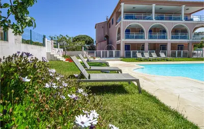 a house with a swimming pool next to a building at Gorgeous Apartment In Propriano in Propriano