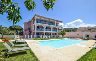 an exterior view of a house with a swimming pool at Cozy Apartment In Propriano With Wifi in Propriano