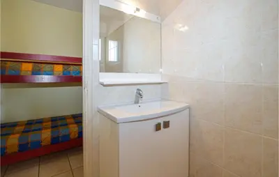 a bathroom with a sink and a mirror at Cozy Apartment In Propriano With Wifi in Propriano