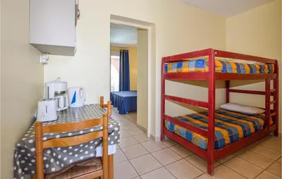 a room with two bunk beds in a room at Cozy Apartment In Propriano With Wifi in Propriano