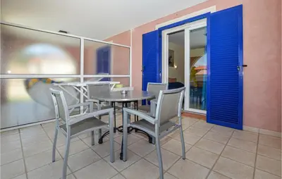a dining room with a table and chairs at Cozy Apartment In Propriano With Wifi in Propriano