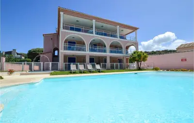 a large swimming pool in front of a building at Cozy Apartment In Propriano With Wifi in Propriano