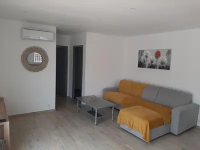 a living room with a couch and a table at Villa_Culomba ALATA -T2 4 couchages in Alata
