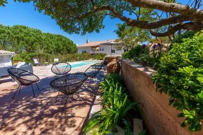 a group of chairs sitting next to a pool at Villa Roma in Prunelli-di-Fiumorbo