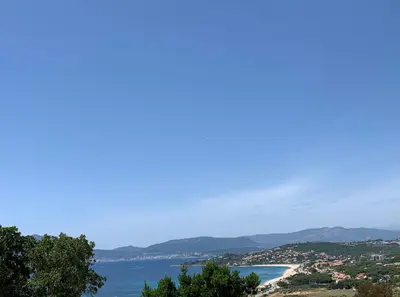 a view of a beach and the ocean at LES VILLAS DU DOMAINE NAPOLEON CORSICA vue mer et piscine in Pietrosella