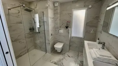 a bathroom with a shower and a toilet and a sink at LES VILLAS DU DOMAINE NAPOLEON CORSICA vue mer et piscine in Pietrosella