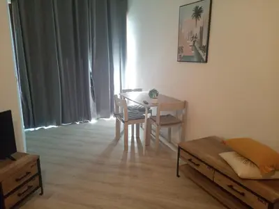 a living room with a table and a table and chairs at Magnifique Studio bord de mer numéro 88 in Santa-Lucia-di-Moriani