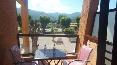 a table and chairs on a balcony with a view at Magnifique Studio bord de mer numéro 88 in Santa-Lucia-di-Moriani