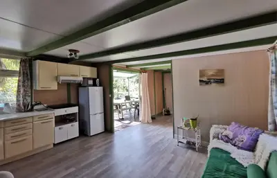 a kitchen and a living room with a couch at PRATICCIONI in Linguizzetta