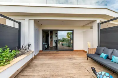 a home with a patio with a couch at Les Jardins de la Palmeraie - Sublime vue sur la baie dAjaccio in Porticcio