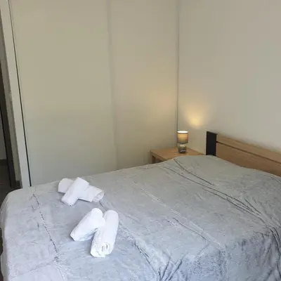 a bed with two rolled towels on top of it at Villa Leku Lucia 8 pers piscine chauffée 15 min plage en voiture in Sainte-Lucie de Porto-Vecchio