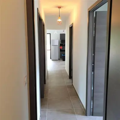 a hallway with a hallway leading to a kitchen at Villa Leku Lucia 8 pers piscine chauffée 15 min plage en voiture in Sainte-Lucie de Porto-Vecchio