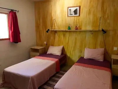 a room with two beds in a room at Villa de plein pied en campagne bonifacienne 84m2. in Bonifacio