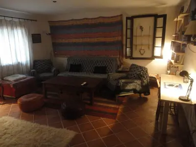 a living room with a couch and a table at Villa de plein pied en campagne bonifacienne 84m2. in Bonifacio