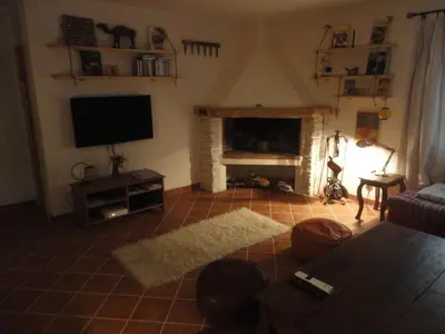 a living room with a television and a fireplace at Villa de plein pied en campagne bonifacienne 84m2. in Bonifacio