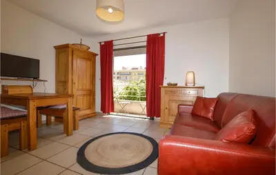 a living room with a couch and a table and a window at Gorgeous Apartment In Propriano in Propriano