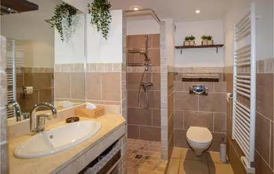 a bathroom with a sink and a toilet and a shower at Gorgeous Apartment In Propriano in Propriano