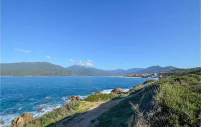 a view of the ocean with mountains in the distance at Gorgeous Apartment In Propriano in Propriano