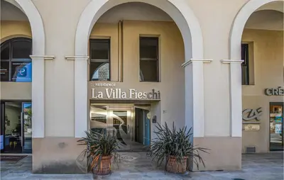 a building with three arches and a sign on it at Gorgeous Apartment In Propriano in Propriano