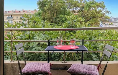 a table with two glasses on top of a balcony at Gorgeous Apartment In Propriano in Propriano