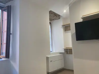 a room with a flat screen tv on a wall at Charmant studio au cœur de la rue Fesch d'Ajaccio in Ajaccio