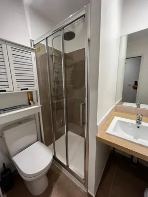 a bathroom with a shower and a toilet and a sink at Charmant studio au cœur de la rue Fesch d'Ajaccio in Ajaccio