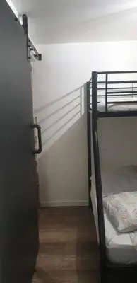 a room with a bunk bed with a door open at Charmant petit studio proche départ GR20 in Calenzana