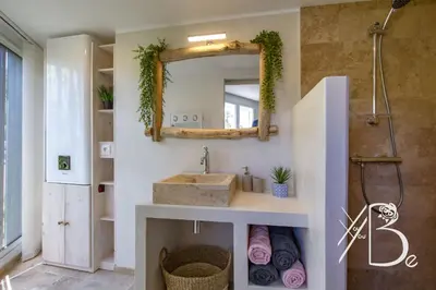 a bathroom with a sink and a mirror at Résidence de Porticcio youyoube2 in Porticcio