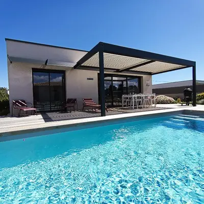a deck with a pool and chairs and a grill at Villa intimiste avec piscine privée chauffée in Lecci