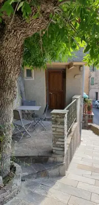 a table and chair in front of a house at Appartement de charme vieille ville in Corte