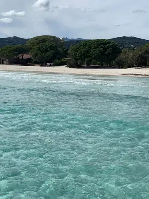 a body of water with a beach in the background at Résidence Costa Nera Santa Giulia in Porto-Vecchio
