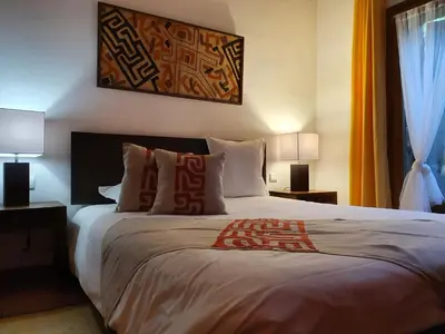 a bedroom with a large bed with two lamps at Domaine Codaleone in Serriera