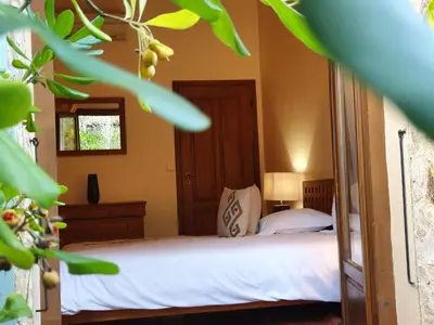 a bedroom with a bed with white sheets and a window at Domaine Codaleone in Serriera