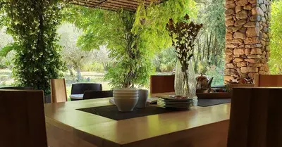 a wooden table with plates and cups on top of it at Domaine Codaleone in Serriera