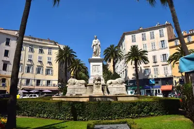 a statue in the middle of a park with buildings at BRILOC AJACCIO centre ville in Ajaccio
